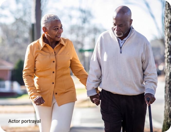 elderly couple walking and holding hands