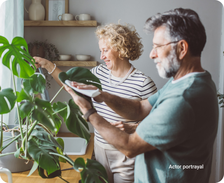peaceful man and woman tending to house plants