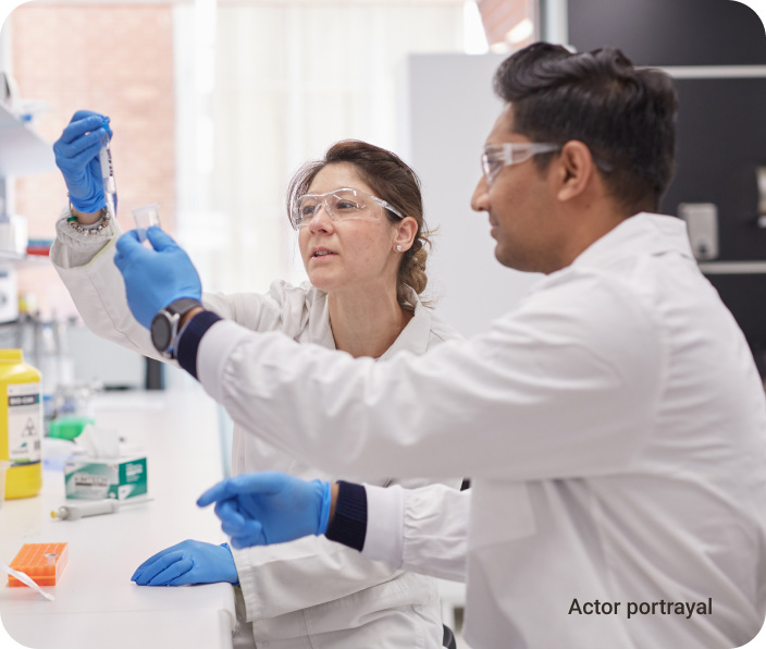 scientists examining vials