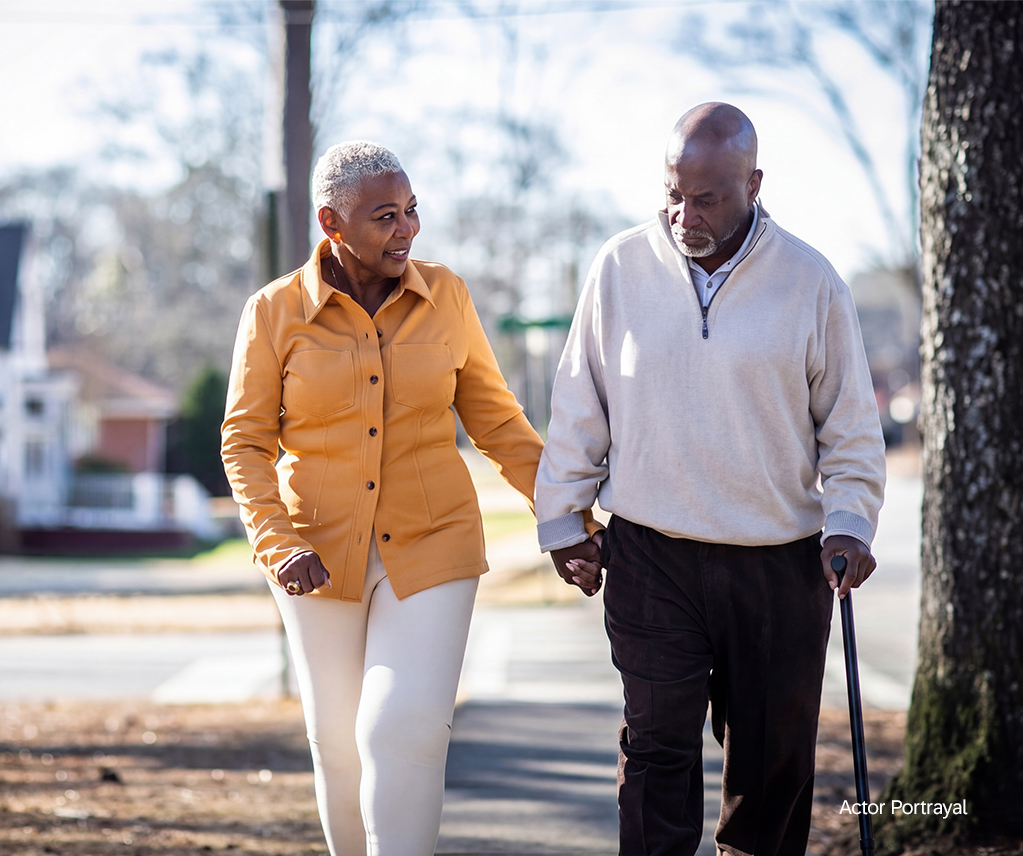 elderly man and woman of color walking