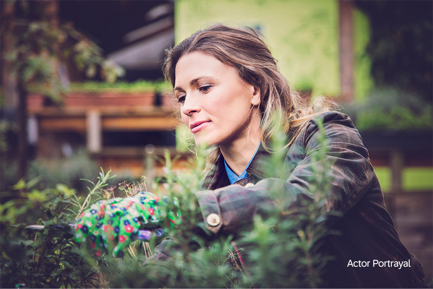 woman working in garden with gardening gloves